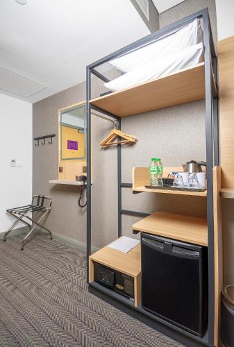a room with a bunk bed with a desk at Premier Inn Dubai International Airport in Dubai