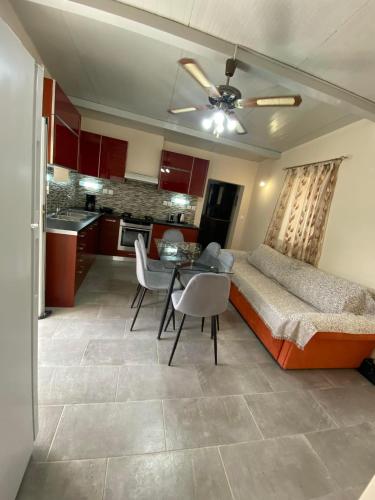a living room with a couch and a table and a kitchen at Sappir House in Pigadhákia