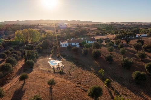 an aerial view of a house in a field at Além Monte Retreat, Peaceful Hideaway on the Alentejo Coast in Colos