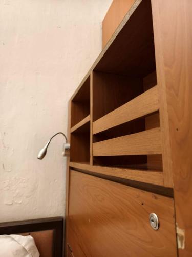 a wooden cupboard with a lamp on top of it at Red Inn Court in George Town