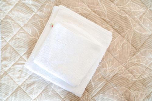 a white napkin sitting on top of a bed at Villa Ljupce in Ohrid