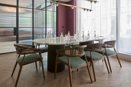 a dining room with a glass table and chairs at The Store in Oxford