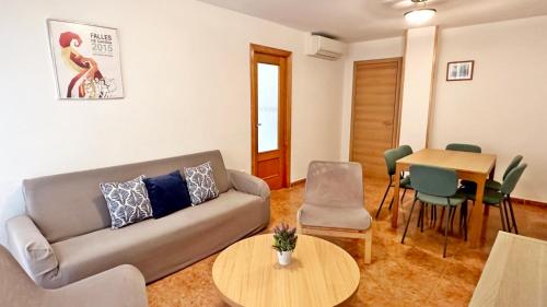 a living room with a couch and a table at TARONGERS MIRAMAR PLAYA - Alquiler solo a Familias in Miramar