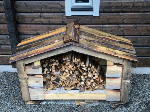 a pile of fire wood in a wooden dog house at Björnrike Fjällstuga in Vemdalen