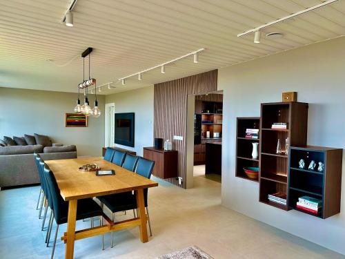 a dining room and living room with a table and chairs at Hrossholt in Stykkishólmur