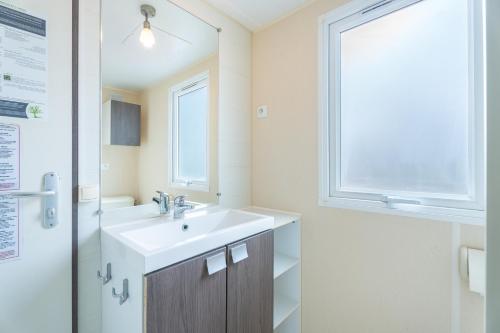 a bathroom with a sink and a window at Falaguera Bungalow 1 in Bárig