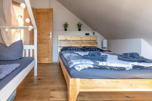 a bedroom with a bed with blue sheets at Wellnessparadies mit Sauna und Whirlpool in Krakow am See