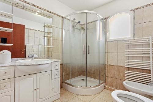une salle de bain avec une douche, des toilettes et un lavabo dans l'établissement Villa Lucio, à La Londe-les-Maures