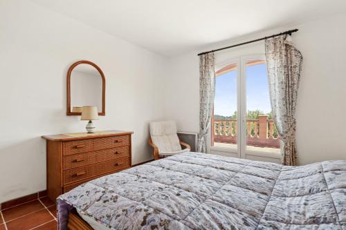 - une chambre avec un lit, une fenêtre et une commode dans l'établissement Villa Lucio, à La Londe-les-Maures