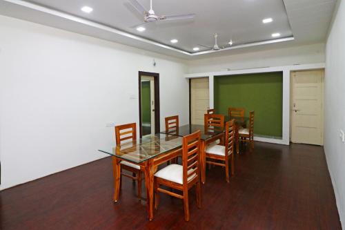 a conference room with a table and chairs and a green screen at Hotel O Krishna Hotel and Restaurant in Raipur