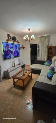 a living room with a couch and a coffee table at Terraza al mar in Salobreña