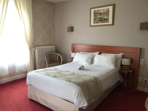 a bedroom with a large bed and a window at Logis Hotel & Restaurant La Paix in Le Nouvion-en-Thiérache