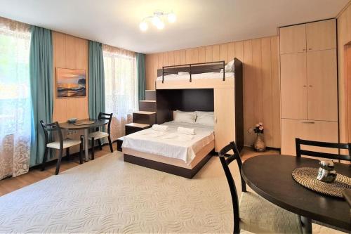 a bedroom with a bed and a desk and a table at MATEO Golden Sands 2 in Golden Sands