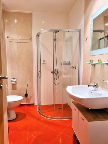a bathroom with a shower and a sink and a toilet at MATEO Golden Sands 2 in Golden Sands