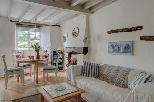 a living room with a couch and a table at The White Cottage in Woodstock
