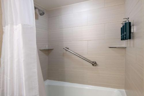 a bathroom with a shower with a shower curtain at DoubleTree by Hilton Washington DC – Crystal City in Arlington