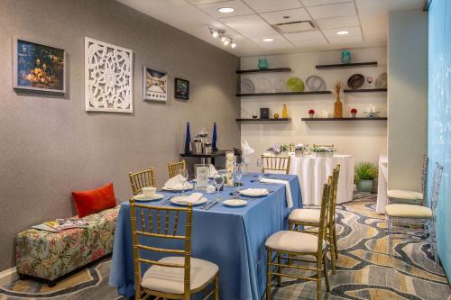 a dining room with a blue table and chairs at DoubleTree by Hilton Hotel and Conference Center Chicago North Shore in Skokie