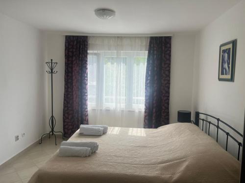 a bedroom with a large bed with two towels on it at Apartment Tihana in Cres