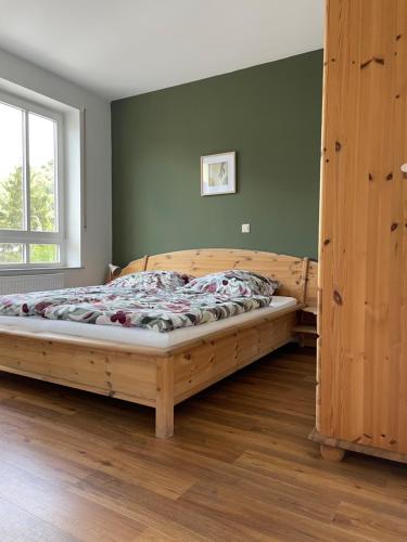 a bedroom with a wooden bed in a room at Ferienwohnung Röttgen in Winningen