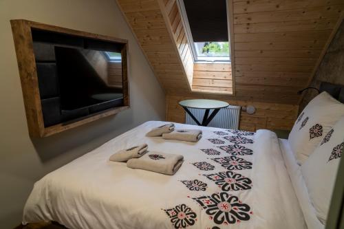 a bedroom with a bed with towels on it at Władysławka in Rabka-Zdroj