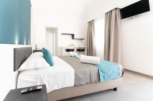 a bedroom with a bed with blue pillows at La dimora del cavatore in Favignana