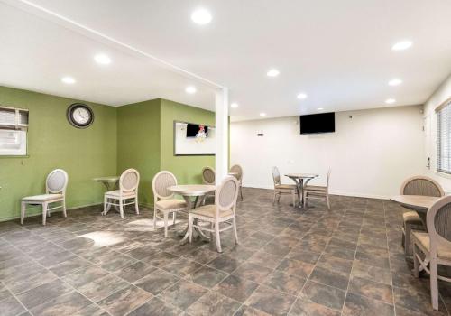 a waiting room with tables and chairs and a clock at Quality Inn South Lake Tahoe in South Lake Tahoe