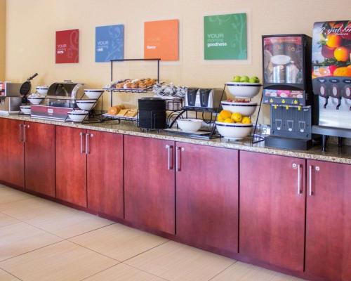 a buffet line with fruits and plates of food at Comfort Inn & Suites Trussville I-59 Exit 141 in Trussville