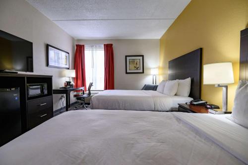 a hotel room with two beds and a television at Quality Inn & Suites Lexington South in Lexington