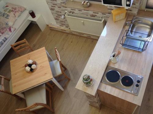 an overhead view of a kitchen with a table and a counter top at Rael-Boardinghouse in Bielefeld