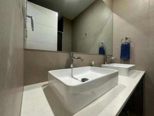 a bathroom with a white sink and a mirror at Stockmans in Truganina