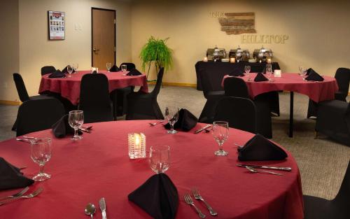 a room with two tables with red table cloths at Coast Hilltop Inn in Pullman
