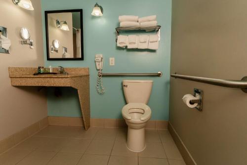a bathroom with a toilet and a sink at Gateway Hotel & Suites, an Ascend Collection Hotel in Ocean City
