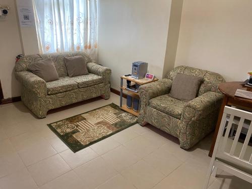 a living room with a couch and a chair at Brookville in Georgetown