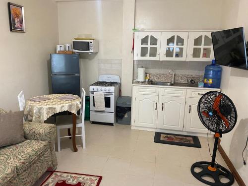 a living room with a couch and a kitchen at Brookville in Georgetown