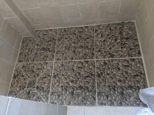 a shower with a stone wall in a bathroom at Brookville in Georgetown
