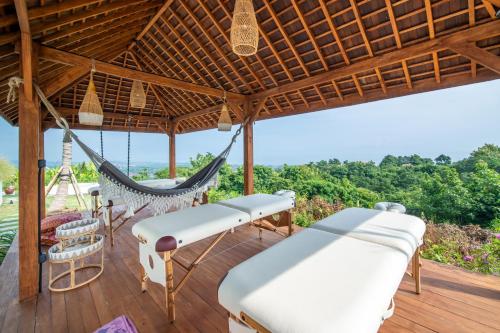a hammock on the deck of a villa at Villa Irrawaddy Lovina in Lovina