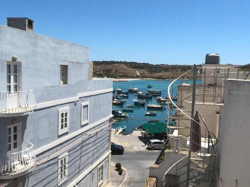 a view of a harbor with boats in the water at Charming Townhouse - Steps from Waterfront in Marsaxlokk