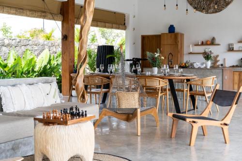 a living room with a table and chairs at Villa Irrawaddy Lovina in Lovina