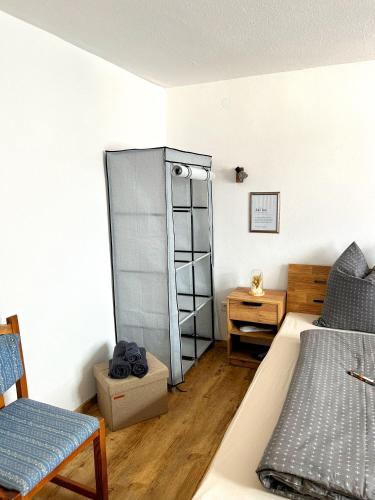 a room with a bed and a dresser in a room at Gemse-Schneiders Wohnen auf dem Bauernhof in Schollbrunn