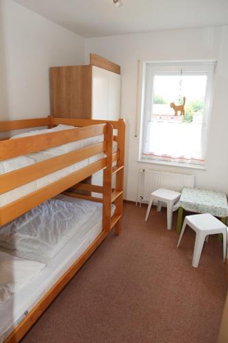 a bedroom with two bunk beds and a window at Jantje in Norddeich