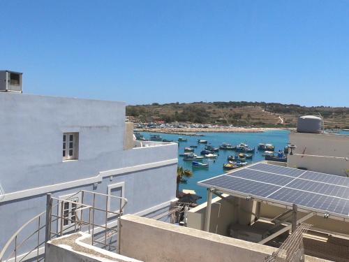 a view of a harbor with boats in the water at Charming Townhouse - Steps from Waterfront in Marsaxlokk