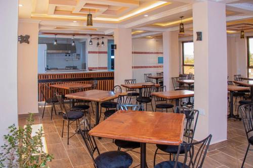 a row of tables and chairs in a restaurant at Grand Skyline Hotel in Nakuru