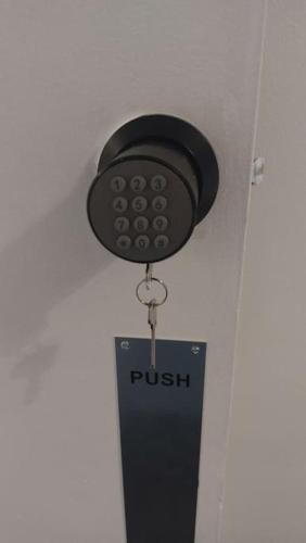 a push sign hanging from the ceiling of a room at St Pancras Private Rooms in London