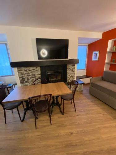 a living room with a table and a fireplace at Porto 03 in Albosaggia