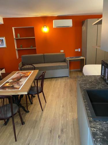 a living room with a couch and a table at Porto 03 in Albosaggia