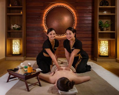two women getting a massage in a room at Kempinski Hotel Grand Arena Bansko in Bansko
