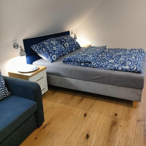 a bedroom with a bed and a couch at APARTAMENTY BAŁTYCKA 4d in Rowy