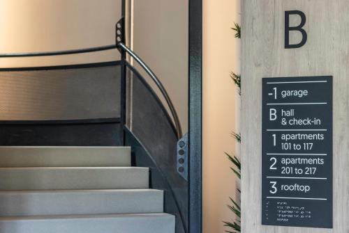 a set of stairs with a sign on the door at Apartamentos Líbere Pamplona Yamaguchi in Pamplona