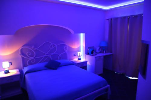 Letto o letti in una camera di Santa Margherita Suite - CHIAIOLELLA