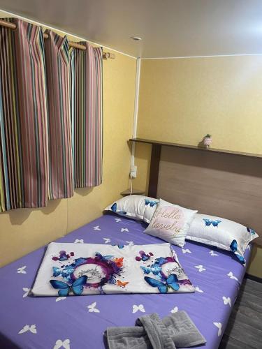 a bedroom with a bed with butterflies on it at Casă mobilă 3 in Constanţa